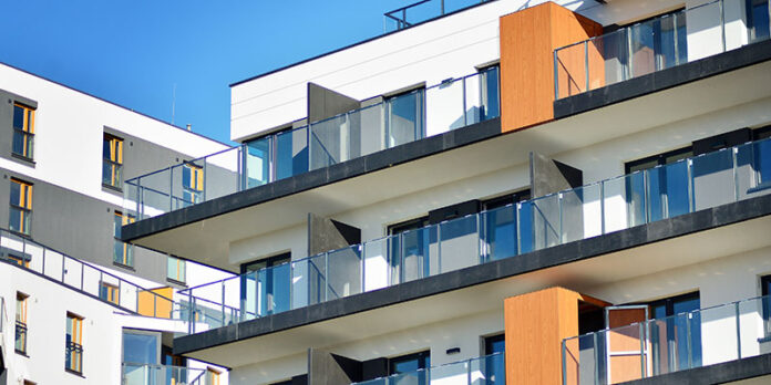Modern apartment buildings on a sunny day with a blue sky.